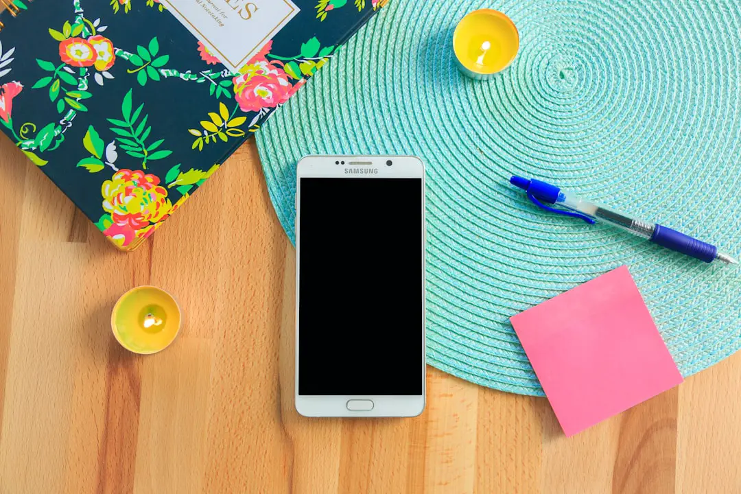 FAQ (#faq) by Case Brands white Samsung Galaxy smartphone on top of blue place mat near blue click pen