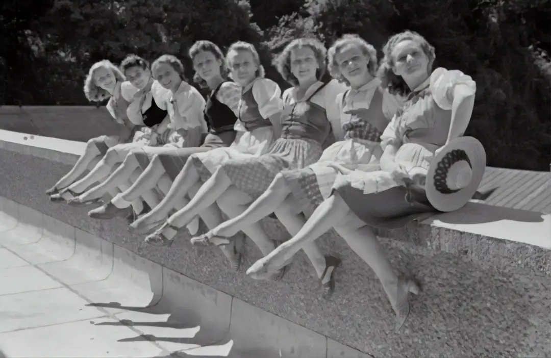Salzburg Festival 1946 by Case Brands grayscale photo of group of women sitting on concrete bench