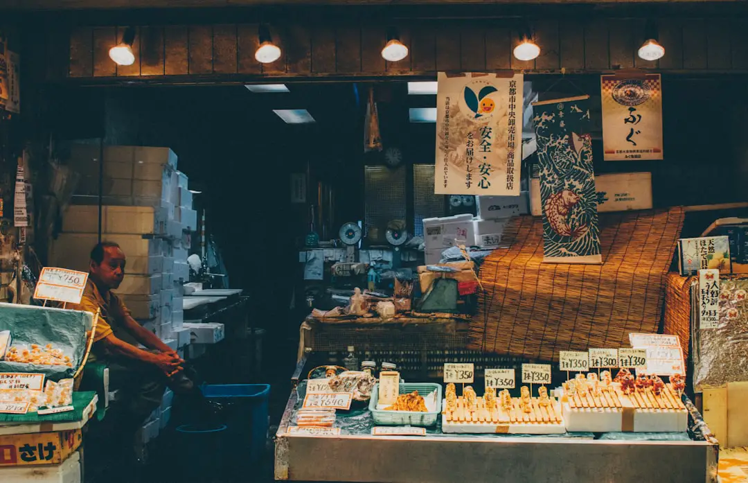 Elderly street vendor by Case Brands person sitting inside store