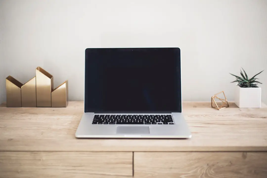 Ugmonk by Case Brands MacBook Pro on top of brown table